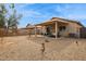 Spacious backyard featuring a covered patio, gravel landscaping, and a block wall at 16729 N 157Th Ave, Surprise, AZ 85374