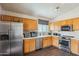 Well-equipped kitchen with stainless steel appliances, light wood cabinets and white countertops at 16729 N 157Th Ave, Surprise, AZ 85374