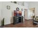Living area with a large TV, minimalist decor, and updated vinyl flooring at 16729 N 157Th Ave, Surprise, AZ 85374