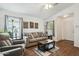 Bright living room with comfortable seating, wood-look floors, and natural light at 16729 N 157Th Ave, Surprise, AZ 85374