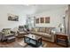 Comfortable living room with plush seating, desert artwork, and a cozy area rug at 16729 N 157Th Ave, Surprise, AZ 85374
