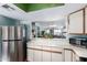 Bright kitchen with modern stainless steel appliances, ample counter space, and pass-through to living area at 16739 E El Lago Blvd # 202, Fountain Hills, AZ 85268
