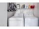 The laundry room area features modern washer and dryer with storage space above at 16739 E El Lago Blvd # 202, Fountain Hills, AZ 85268