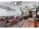 Inviting living room with wood flooring, a ceiling fan, and open dining area with a decorative wall at 16739 E El Lago Blvd # 202, Fountain Hills, AZ 85268