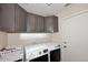 Convenient laundry area with modern washer and dryer units plus storage at 17606 N 17Th Pl # 1115, Phoenix, AZ 85022
