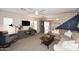 Cozy open-concept living area with a sofa, TV and access to the dining area at 17606 N 17Th Pl # 1115, Phoenix, AZ 85022