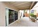 Inviting covered patio features sleek sliding glass doors and stylish outdoor seating, perfect for relaxing and entertaining at 17606 N 17Th Pl # 1115, Phoenix, AZ 85022
