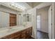 Bathroom featuring double sink vanity, wall of storage and access to the pool area at 17790 N 66Th Ln, Glendale, AZ 85308