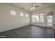 Bright bedroom with wood-look floors, a ceiling fan, and multiple windows at 17790 N 66Th Ln, Glendale, AZ 85308