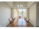 Bright dining room with tray ceilings, a large window, and a wooden table with chairs at 17790 N 66Th Ln, Glendale, AZ 85308