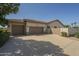 Home with a tile roof, a wide driveway, and an attached two-car garage at 17790 N 66Th Ln, Glendale, AZ 85308