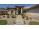 Inviting home entrance with desert landscaping and a walkway leading to the front door at 17790 N 66Th Ln, Glendale, AZ 85308