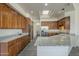 A spacious kitchen with stainless steel appliances, granite counters, and ample wooden cabinets at 17790 N 66Th Ln, Glendale, AZ 85308