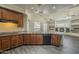 Well-lit kitchen boasts wood cabinetry, granite countertops, and modern appliances for cooking convenience at 17790 N 66Th Ln, Glendale, AZ 85308