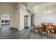 Open living area with wood-look floors, high ceilings, and views into other rooms at 17790 N 66Th Ln, Glendale, AZ 85308