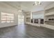 Bright living room featuring a fireplace, tiled floors, and views of the backyard through sliding glass doors at 17790 N 66Th Ln, Glendale, AZ 85308