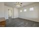 Main bedroom with wood-look flooring, ceiling fan, and ensuite bathroom at 17790 N 66Th Ln, Glendale, AZ 85308