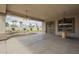 Covered patio with ceiling fans leads to a private pool featuring a rock waterfall and desert landscaping at 17790 N 66Th Ln, Glendale, AZ 85308