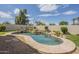 Backyard pool with decorative rock waterfall feature and desert landscaping against a block wall backdrop at 17790 N 66Th Ln, Glendale, AZ 85308