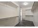 Spacious walk-in closet with custom shelves and racks for ample storage and organization at 17790 N 66Th Ln, Glendale, AZ 85308