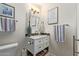 Bathroom with a white vanity, mosaic tile backsplash, and a framed mirror at 18725 N 92Nd Dr, Peoria, AZ 85382