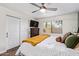 Bedroom with a window, ceiling fan, closet, and a dresser with TV at 18725 N 92Nd Dr, Peoria, AZ 85382