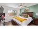 Comfortable bedroom with a ceiling fan, accent wall, and a serene atmosphere at 18725 N 92Nd Dr, Peoria, AZ 85382