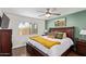 Comfortable bedroom with a ceiling fan, accent wall, and a serene atmosphere at 18725 N 92Nd Dr, Peoria, AZ 85382