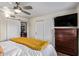 Bedroom with sliding closet doors, ceiling fan, and an entry to a kitchen at 18725 N 92Nd Dr, Peoria, AZ 85382