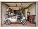 Garage showcasing a golf cart and a parked vehicle for convenient transportation at 18725 N 92Nd Dr, Peoria, AZ 85382