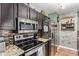 Well-equipped kitchen with stainless steel appliances and custom backsplash at 18725 N 92Nd Dr, Peoria, AZ 85382