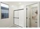 Shower room with glass door, window, and white paint at 19022 W Rose Ln, Waddell, AZ 85355