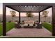 This covered patio has stylish outdoor seating, and it is perfect for relaxing or entertaining guests at 19022 W Rose Ln, Waddell, AZ 85355