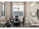 Elegant dining area adjacent to kitchen, featuring a round table, stylish chairs, and natural light at 19022 W Rose Ln, Waddell, AZ 85355