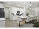 Well-lit kitchen with stainless steel appliances, a large island with pendant lighting, and wood look floors at 19022 W Rose Ln, Waddell, AZ 85355