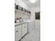 Laundry room with shelving, storage, patterned floor, and modern machines at 19022 W Rose Ln, Waddell, AZ 85355