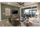 Inviting living room with a ceiling fan, modern decor, and a large sliding glass door to the outdoor patio at 19022 W Rose Ln, Waddell, AZ 85355