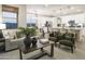 Inviting living room showcasing a modern design, cozy seating, and seamless flow to the kitchen area at 19022 W Rose Ln, Waddell, AZ 85355