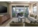 Comfortable living room with modern furnishings, a large sliding glass door to the outdoor living area at 19022 W Rose Ln, Waddell, AZ 85355