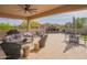 Inviting covered patio with a stone fireplace, comfortable seating, and an outdoor kitchen perfect for entertaining guests at 1904 N Steele --, Mesa, AZ 85207