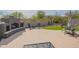 The cozy backyard features a stone fireplace, comfortable seating, and synthetic grass at 1904 N Steele --, Mesa, AZ 85207