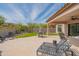 Relax on the spacious backyard patio featuring stylish seating and views of the landscaped yard at 1904 N Steele --, Mesa, AZ 85207