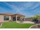 Beautiful backyard with a covered patio, outdoor seating, and a lush, green artificial turf area at 1904 N Steele --, Mesa, AZ 85207