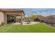 Resort-style backyard featuring a covered patio, fireplace, outdoor seating, and artificial turf at 1904 N Steele --, Mesa, AZ 85207