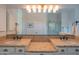 Bathroom with double sinks, granite counters, and a glass shower with a mosaic tile floor at 1904 N Steele --, Mesa, AZ 85207