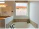 Bright bathroom featuring an oversized tub with granite surround and a large window at 1904 N Steele --, Mesa, AZ 85207