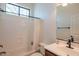 Neutral toned bathroom with tub and shower combo and a vanity with a dark wood finish at 1904 N Steele --, Mesa, AZ 85207