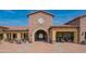 Exterior view of the community clubhouse with a clock tower and outdoor seating areas at 1904 N Steele --, Mesa, AZ 85207
