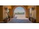 View through the arched entry of the Mountain Bridge clubhouse highlighting the pool and desert landscape at 1904 N Steele --, Mesa, AZ 85207