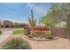 The Mountain Bridge community entrance featuring flowers, desert landscaping, a cactus, and a stone wall at 1904 N Steele --, Mesa, AZ 85207